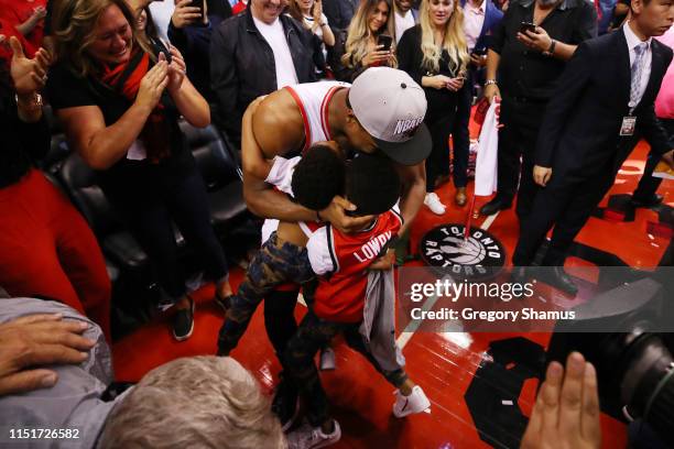 Kyle Lowry of the Toronto Raptors celebrates with his sons Kameron and Karter after defeating the Milwaukee Bucks 100-94 in game six of the NBA...