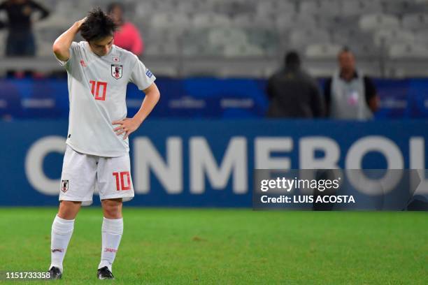 Japan's Shoya Nakajima gestures after tying 1-1 with Ecuador and not reaching the quarter-finals of the Copa America football tournament group match...