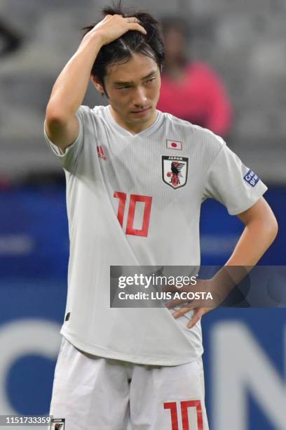 Japan's Shoya Nakajima gestures after tying 1-1 with Ecuador and not reaching the quarter-finals of the Copa America football tournament group match...