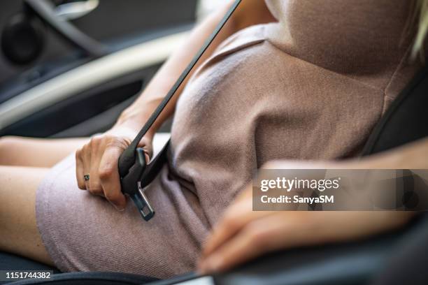 pregnant woman with safety seat belt - pregnant woman car stock pictures, royalty-free photos & images