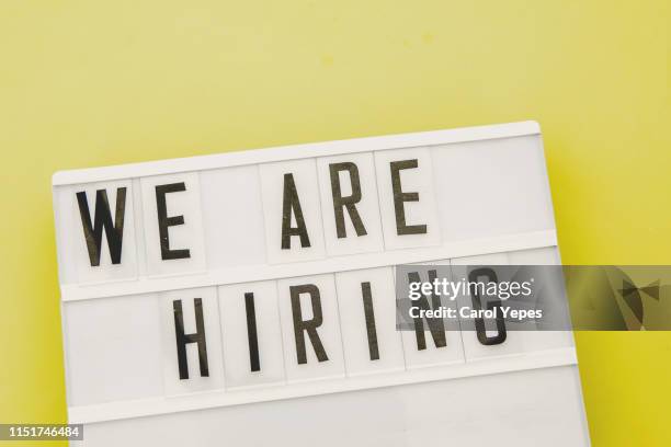 we are hiring text in  lightbox. yellow background - arbeitssuche stock-fotos und bilder