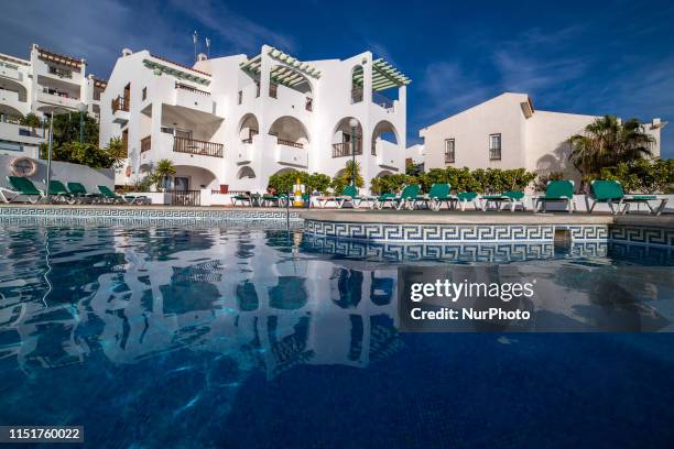 Swimming pool during the day and night at a luxury all-inclusive holidays hotel with view of the ocean at Callao Salvaje, in Tenerife island, Canary...