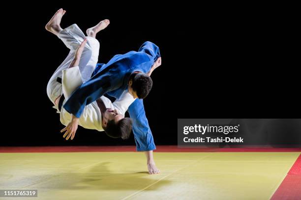 male judo players competing during match - judo stock pictures, royalty-free photos & images