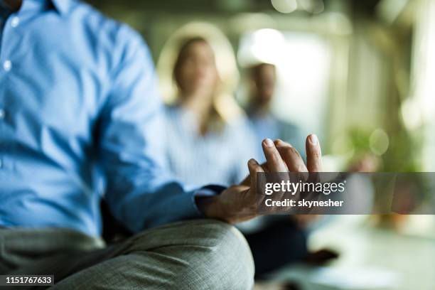 close up of unrecognizable businessman exercising yoga. - office zen stock pictures, royalty-free photos & images