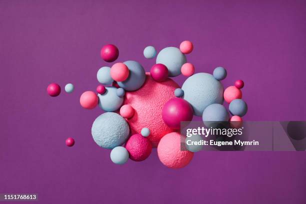 abstract multi-colored spheres on purple background - ondas electromagneticas fotografías e imágenes de stock