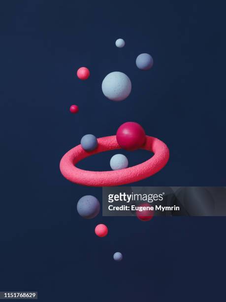 abstract multi-colored spheres on dark blue background - particle sphere stock pictures, royalty-free photos & images