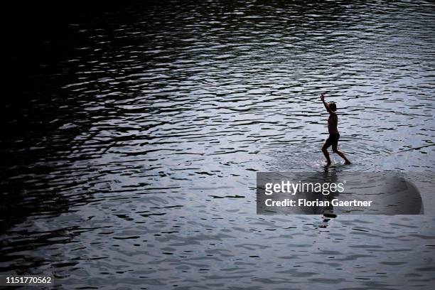 Man balancing on a slackline on the water is pictured on June 23, 2019 in Koenigshain, Germany.