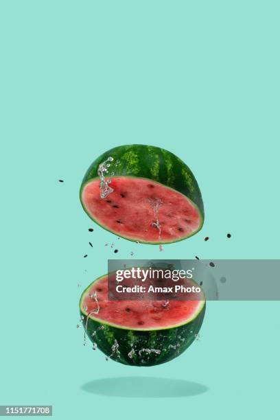 watermelon sliced flying on pastel green background. minimal fruit and summer concept. - fly spray stock pictures, royalty-free photos & images