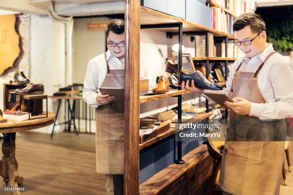 Sales clerk checking shoes in boutique