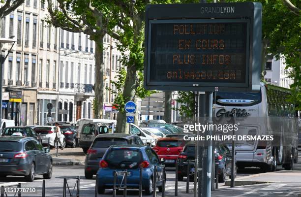 Digital diplay reads 'Ongoing pollution - more info on onlymoov' as cars drive in the French eastern city of Lyon on June 25, 2019 as temperatures...