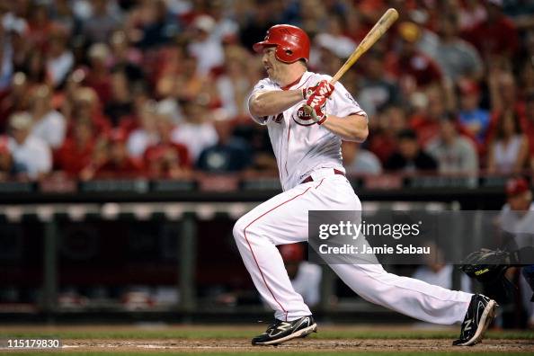 Scott Rolen of the Cincinnati Reds follows through on a hit for a ...