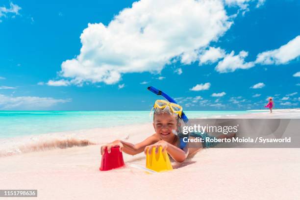 smiling child playing on sand beach, caribbean - harbor island bahamas fotografías e imágenes de stock