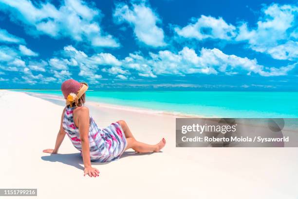 woman sitting on beach admiring the sea, caribbean - martinique beach stock pictures, royalty-free photos & images