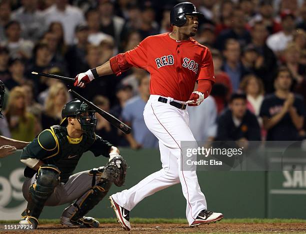 Carl Crawford of the Boston Red Sox hits a 2 RBI single in the seventh inning as Kurt Suzuki of the Oakland Athletics defends on June 3, 2011 at...