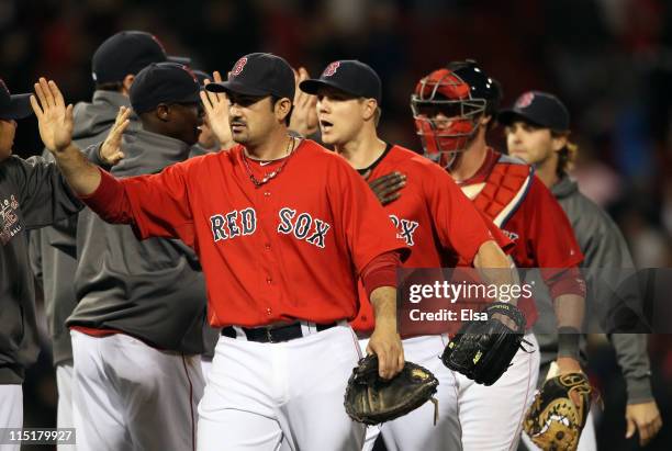 Adrian Gonzalez, Jonathan Papelbon and Jarrod Saltalamacchia of the Boston Red Sox celebrate the win on June 3, 2011 at Fenway Park in Boston,...