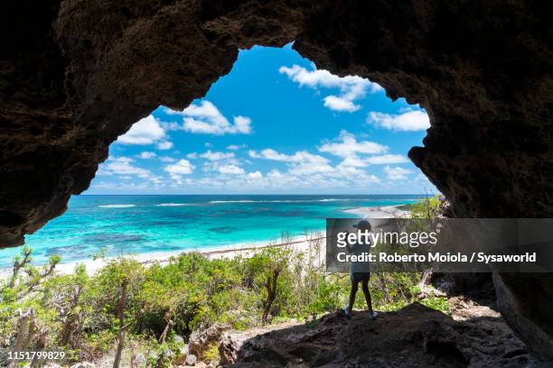child taking photos from cave, two foot bay, barbuda, caribbean - antigua leeward islands bildbanksfoton och bilder