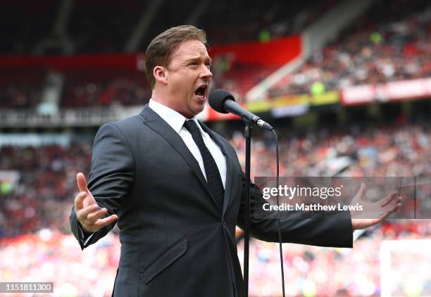 Singer Russell Watson sings ahead of the Manchester United '99 Legends and FC Bayern Legends match at Old Trafford on May 26, 2019 in Manchester,...