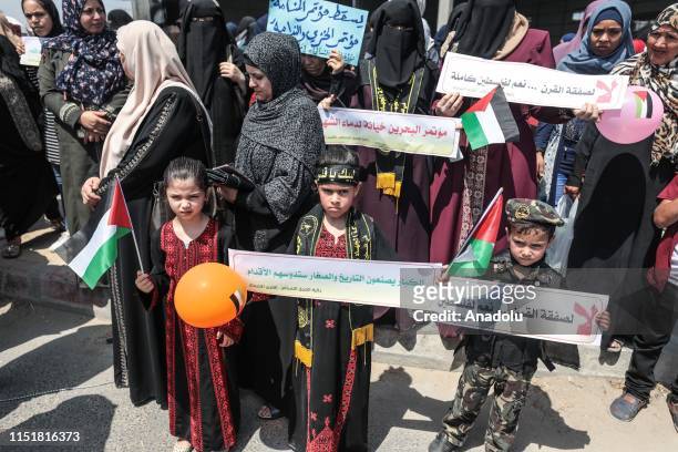 Children hold banners during a protest against the U.S.-led conference in Bahrain on June 25, 2019 in Beit Lahia, Gaza. U.S. Officials are expected...