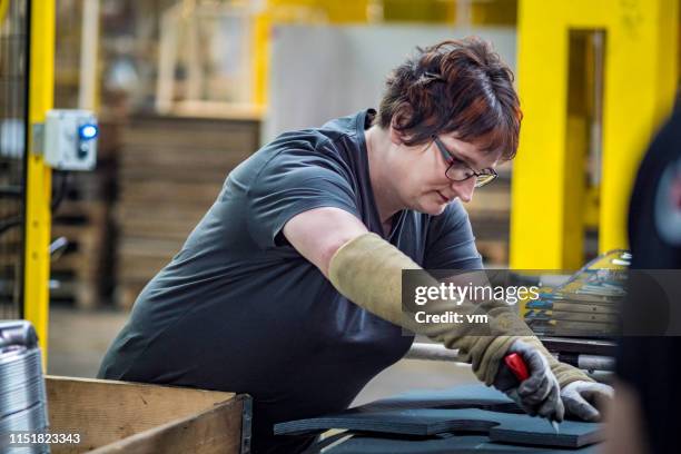 female assembly line worker - craft knife stock pictures, royalty-free photos & images