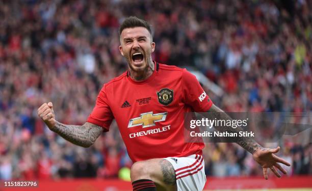 David Beckham of Manchester United celebrates after he scores in action during the Manchester United '99 Legends and FC Bayern Legends at Old...