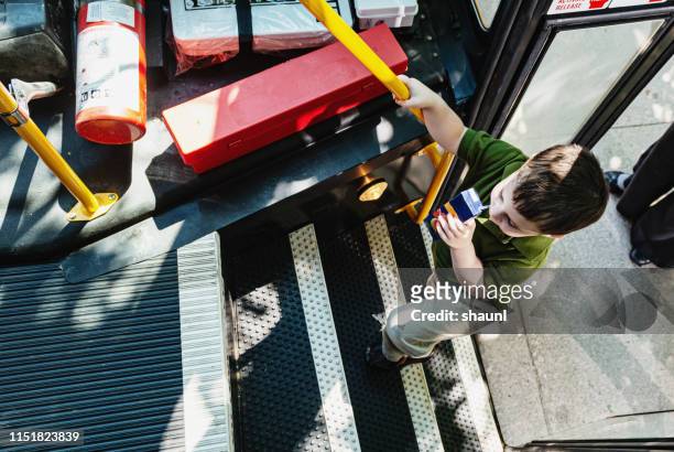 boy gets im schulbus - boarding a bus stock-fotos und bilder
