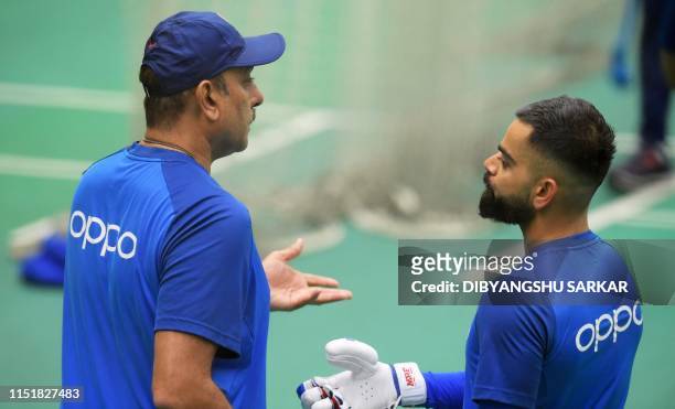 India's head coach Ravi Shastri and India's captain Virat Kohli attend a training session at Old Trafford in Manchester, northwest England on June 25...