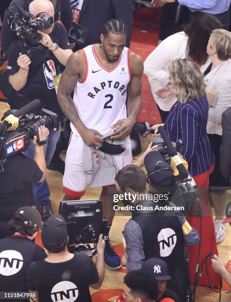 Kawhi Leonard of the Toronto Raptors gets set to be interviewed after victory against the Milwaukee Bucks in Game Six of the NBA Eastern Conference...