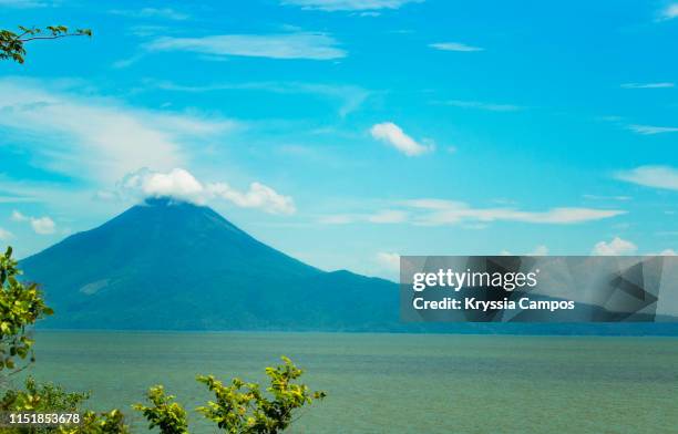 volcano rises beside lake managua (xolotlán) in nicaragua - masaya volcano stock-fotos und bilder