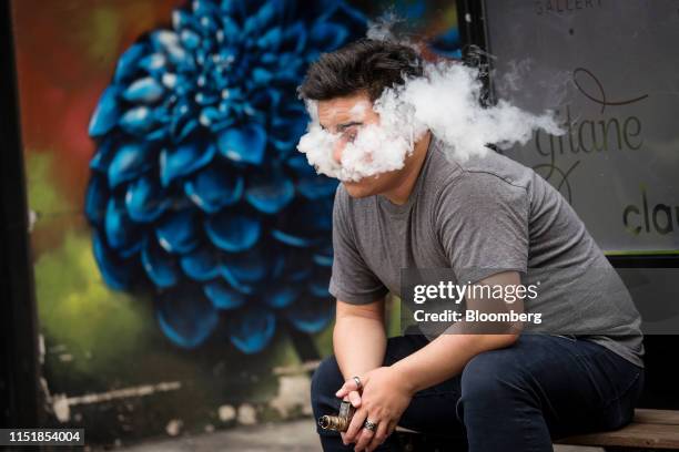 Person exhales vapor while using an electronic cigarette device in San Francisco, California, U.S., on Monday, June 24, 2019. The city will hold a...