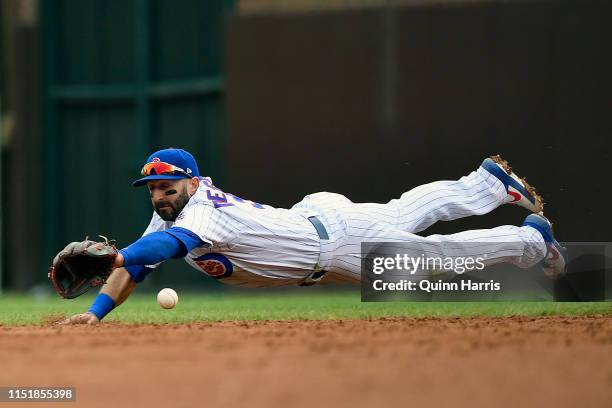 Daniel Descalso of the Chicago Cubs dives for the ball in the third inning against the Cincinnati Reds at Wrigley Field on May 26, 2019 in Chicago,...