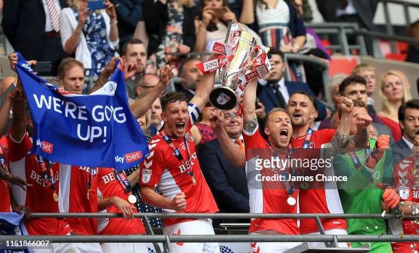 Jason Pearce of Charlton Athletic and Chris Solly of Charlton Athletic lift the trophy following their victory and promotion in the Sky Bet League...