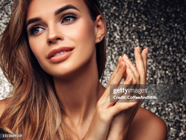 beautiful girl posing on a gold background - curvy model stock pictures, royalty-free photos & images