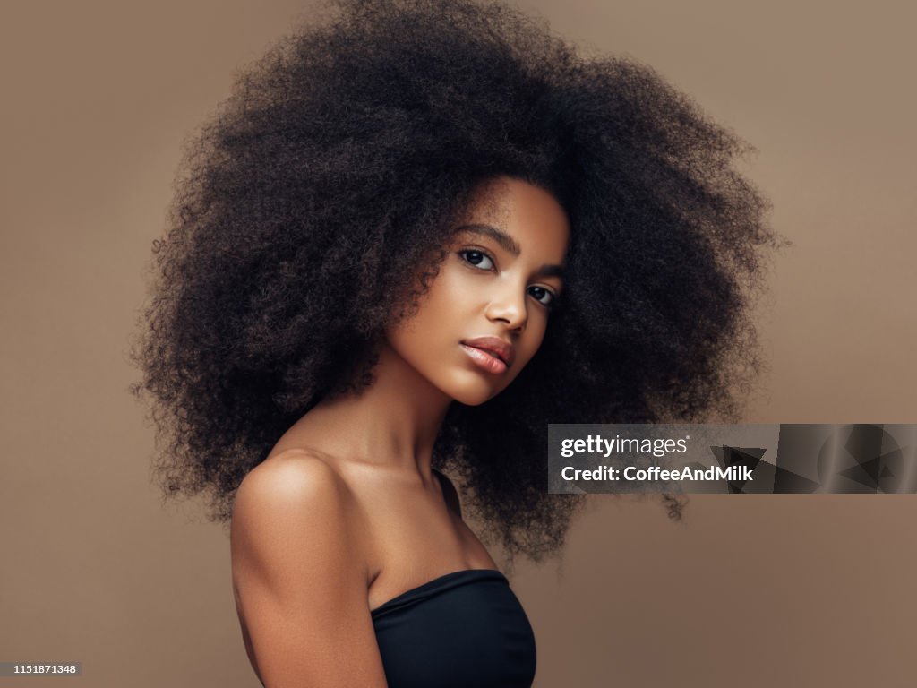 Beautiful smiling girl with curly hairstyle