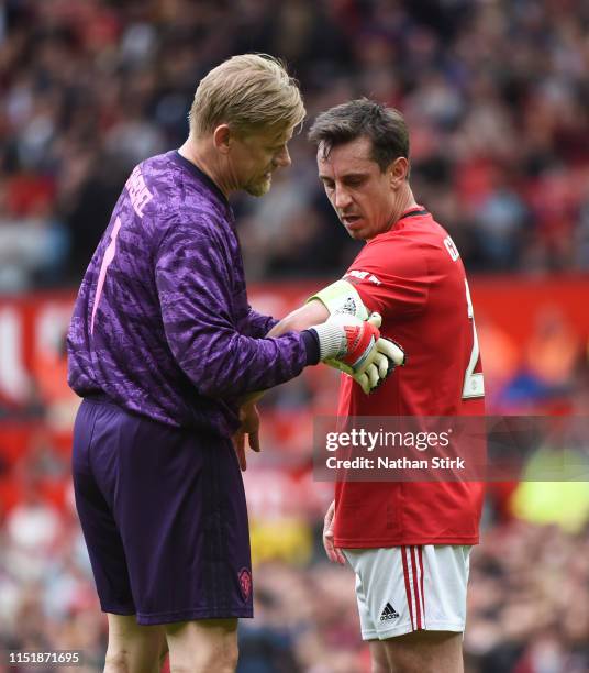 Peter Schmeichel of Manchester United gives the captain's armband to Gary Neville during the Manchester United '99 Legends and FC Bayern Legends at...