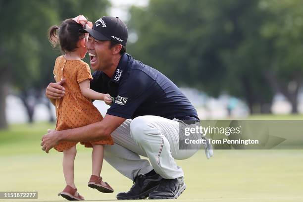 Kevin Na of the United States celebrates with his daughter, Sophia Na, on the 18th green after winning the Charles Schwab Challenge at Colonial...