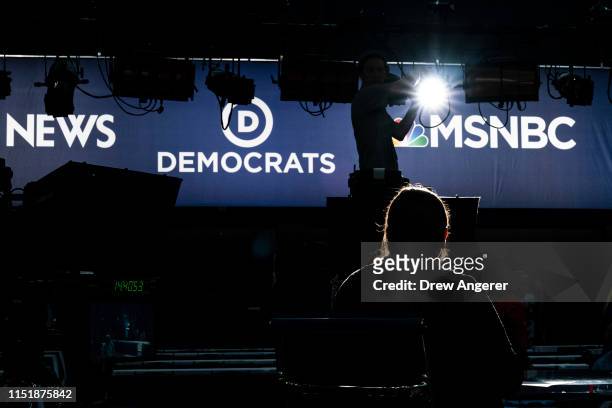 Workers assemble the television set inside the media filing center at Adrienne Arsht Center for the Performing Arts where the first Democratic...