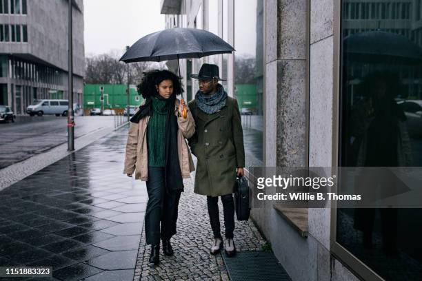 Two Young Black Business People walking on Rainy Day