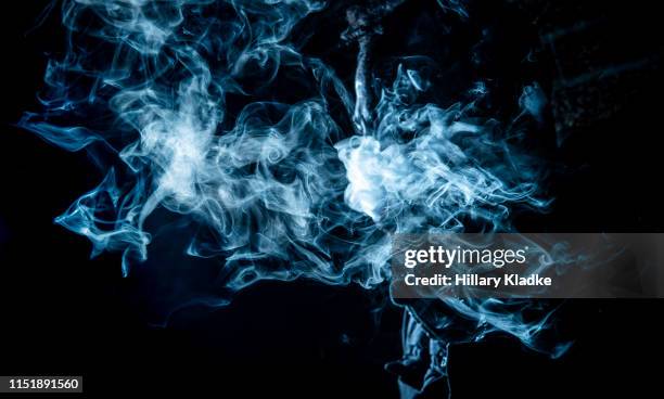 blue wispy smoke on black background - wispy stock pictures, royalty-free photos & images