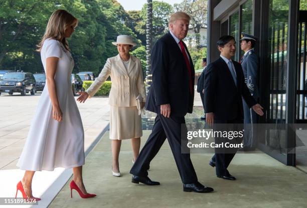 President Donald Trump and First Lady Melania Trump are greeted by Emperor Naruhito and Empress Masako as they arrive at the Imperial Palace on May...