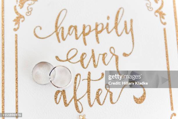 "happily ever after" script and wedding rings - fairy tale font stock pictures, royalty-free photos & images