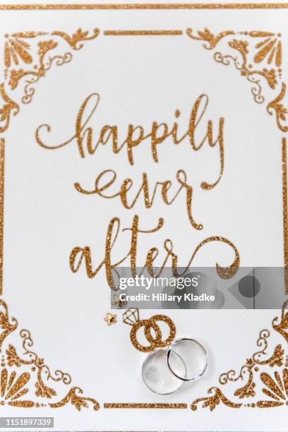 "happily ever after" script and wedding rings - wedding card stock-fotos und bilder