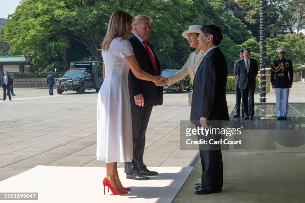 President Donald Trump and First Lady Melania Trump are greeted by Emperor Naruhito and Empress Masako as they arrive at the Imperial Palace on May...