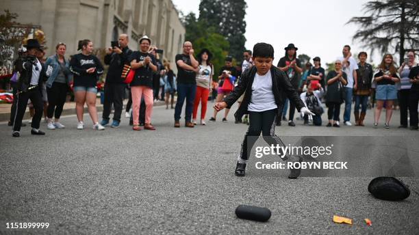 Super fan Dominic Lendo dance as fans gather outside Michael Jackson's final resting place in Forest Lawn Cemetery in Glendale, California to...