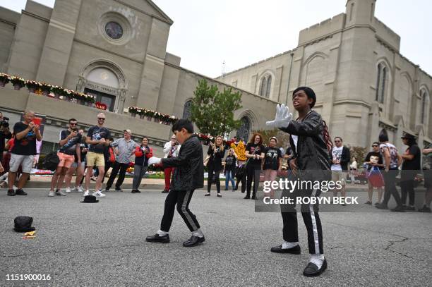 Super fans Tanisha Woods and Dominic Lendo dance as fans gather outside Michael Jackson's final resting place in Forest Lawn Cemetery in Glendale,...