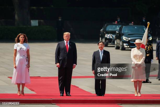 From left to right) Melania Trump, U.S. President Donald Trump, Japan Emperor Naruhito and Empress Masako stand to listen National Anthem during a...