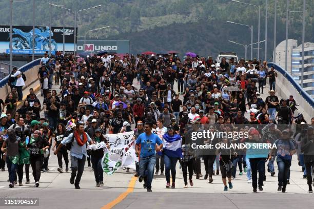 Students of the National Autonomous University of Honduras take part in a demonstration to demand the resignation of Honduran President Juan Orlando...