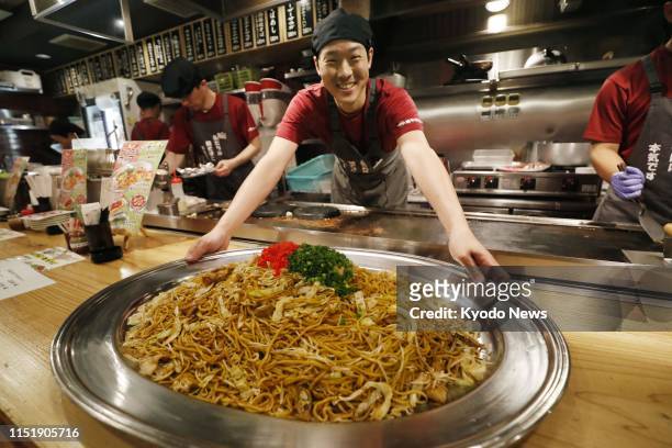 Giant dish of stir-fry "yakisoba" using 20 servings of soba noodles is served at a restaurant in Amagasaki, near Osaka, on June 25, 2019 in a...