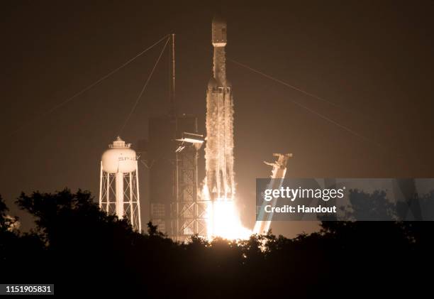 In this handout image provided by NASA, A SpaceX Falcon Heavy rocket carrying 24 satellites as part of the Department of Defense's Space Test...