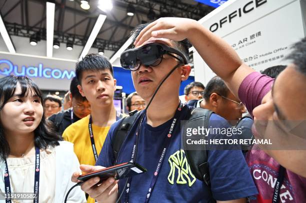 Man tries out an augmented reality headset during the Mobile World Congress introducing next-generation technology at the Shanghai New International...