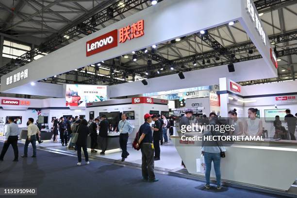 People visit a Lenovo stand during the Mobile World Congress introducing next-generation technology at the Shanghai New International Expo Centre in...
